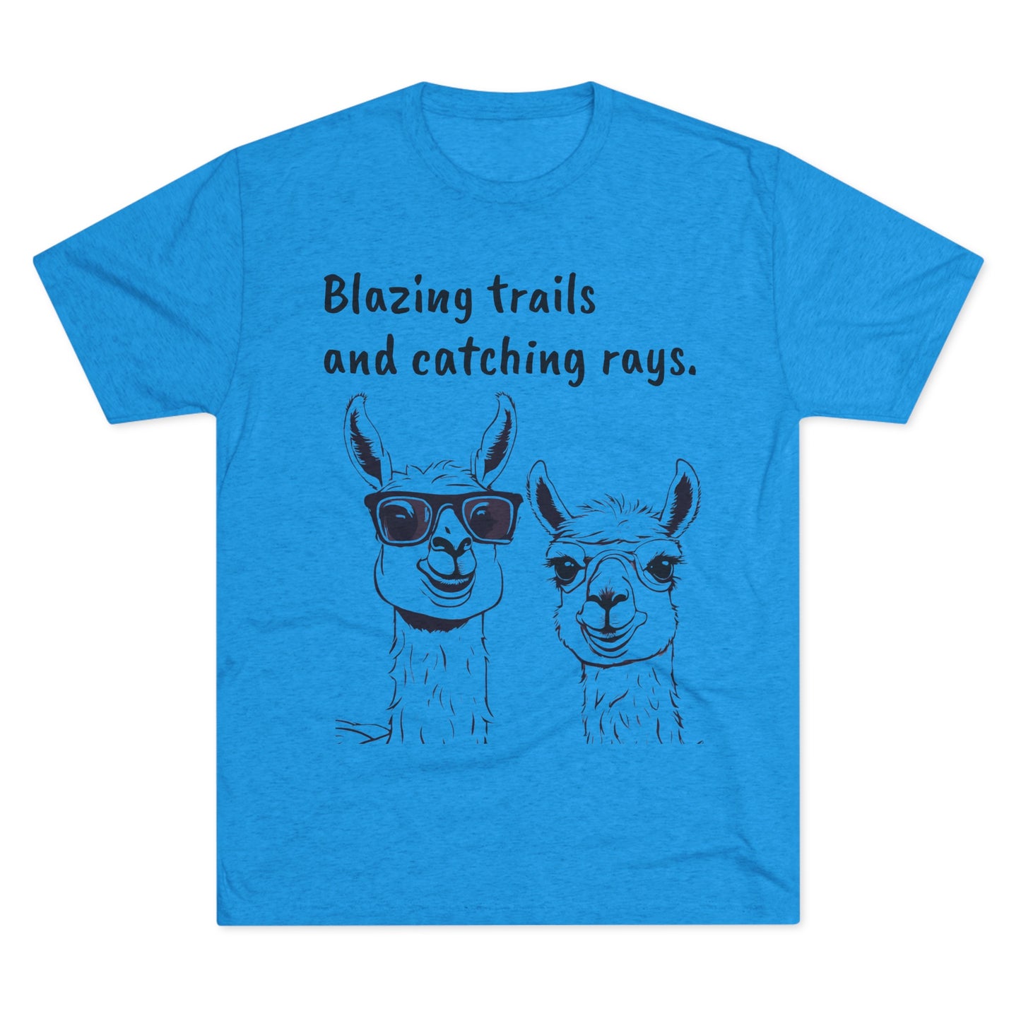 A blue Blazing Trails Llama - Tri-Blend Crew Tee - Unisex Fit from Printify features two cartoon llamas. The llama on the left is wearing sunglasses, while the llama on the right is not. Above them, the text reads, "Blazing Trails and Catching Rays.” Perfect for those with an adventurous spirit!