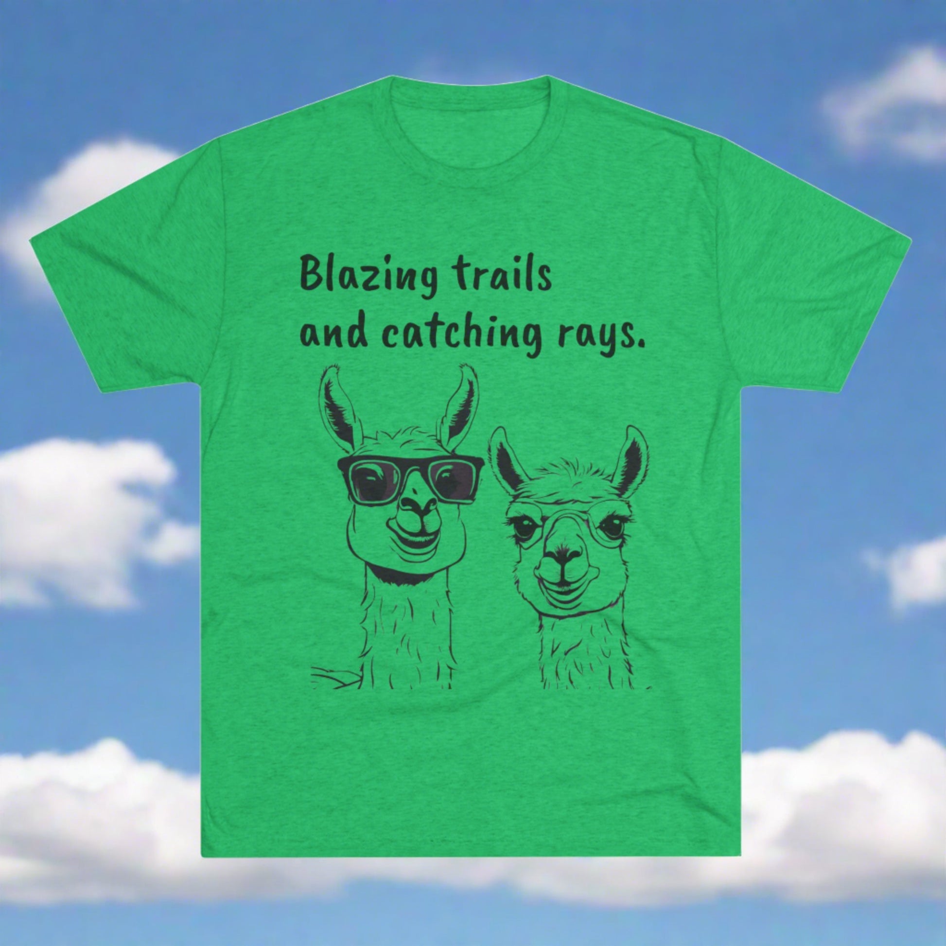 This green "Blazing Trails Llama - Tri-Blend Crew Tee - Unisex Fit," available at Printify, features illustrations of two llamas. One llama wears sunglasses, while the other does not. The black text above them reads, "Blazing trails and catching rays," capturing an adventurous spirit.