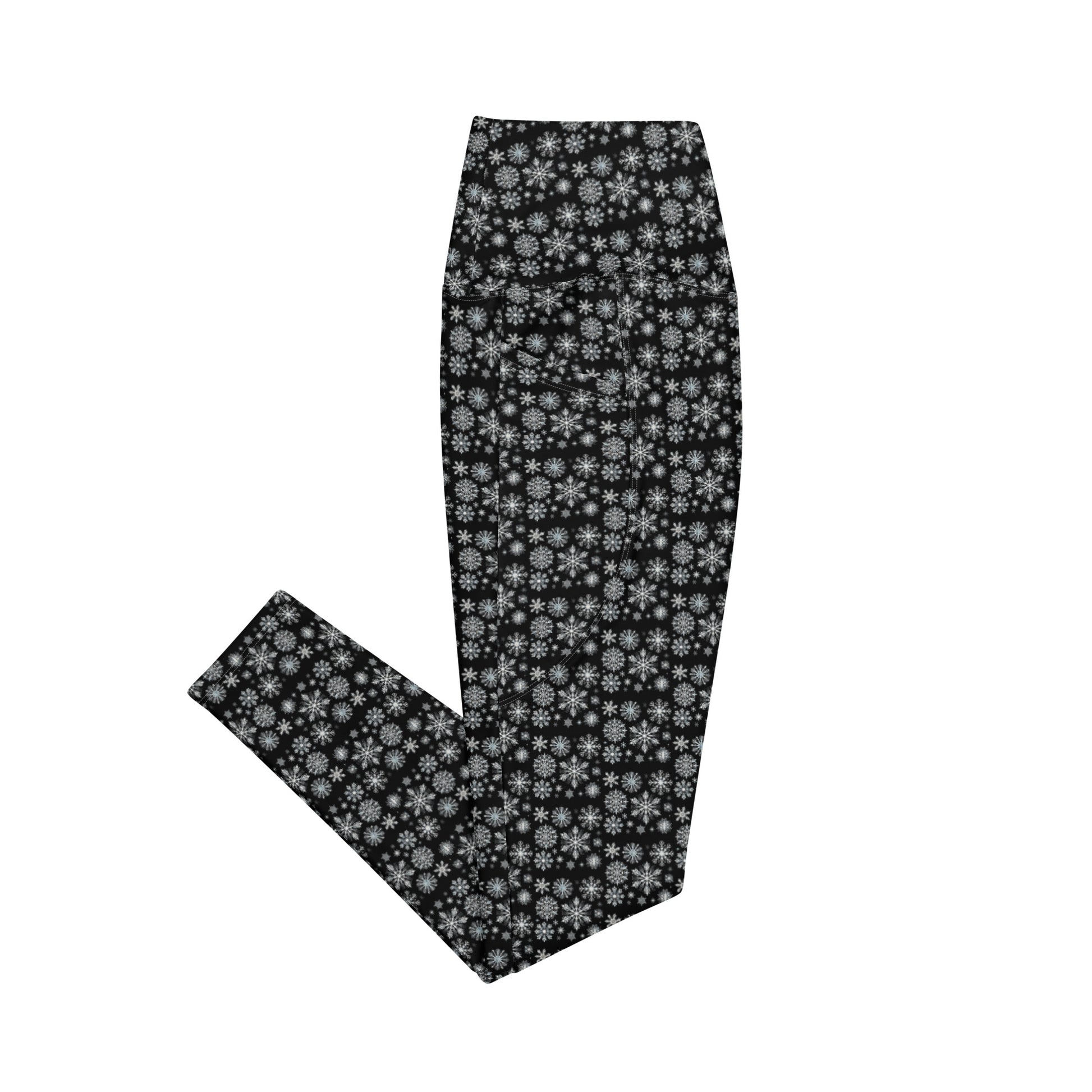 The Snowflakes Leggings with pockets from Blue Sky Runners, featuring a black snowflake pattern, are neatly folded and displayed against a white background, making them perfect for winter workout apparel.