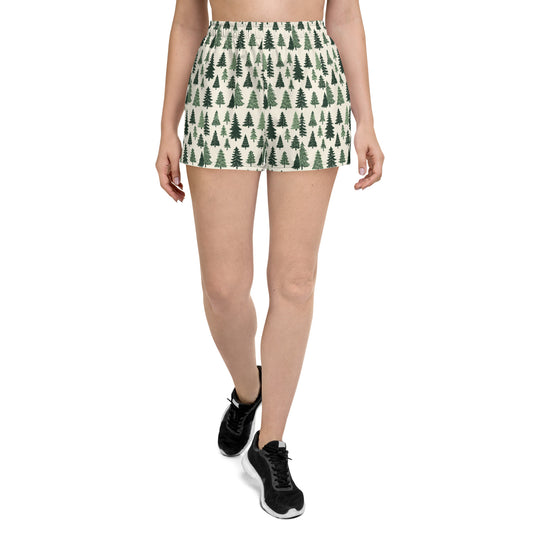 An individual with an active soul is depicted striding confidently, wearing Blue Sky Runners' Frosty Fir Festive Shorts paired with black sneakers. The plain white background accentuates their dynamic presence.